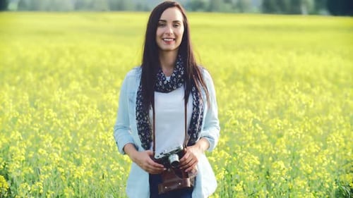 Woman with Vintage Camera in Field of Flowers
