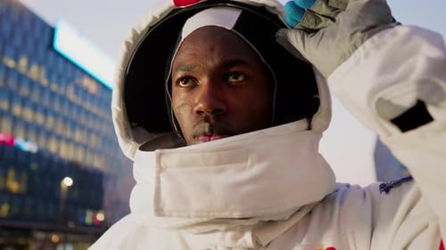 Spaceman opening helmet visor in city