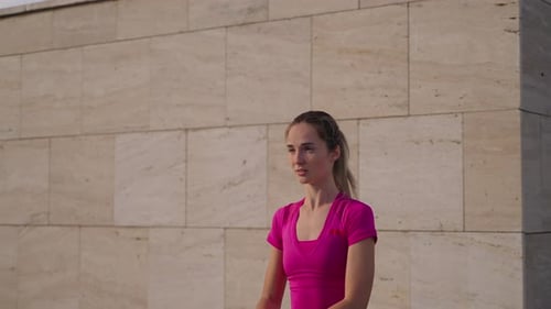 Young Woman is Doing Physical Exercise in City in Morning Yoga Practicing