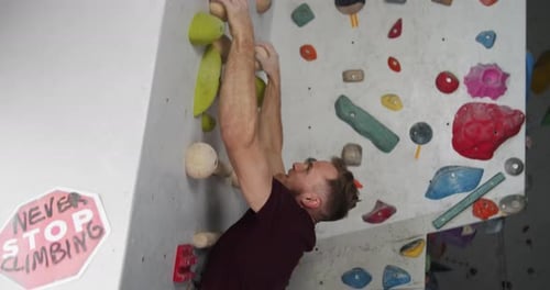 Athletic Man Indoor Rock Climbing Workout
