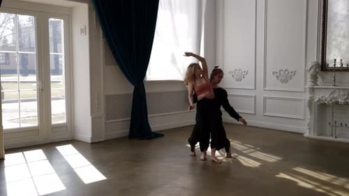 Couple of Young Dancers are Dancing and Rehearsing Dance Performance in Hall Modern Choreography
