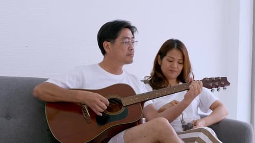 Loving Couple Enjoying Music Together at Home