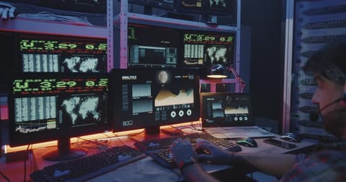 Hacker Using Computer with Multiple Monitors