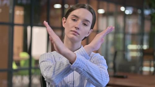 Young Woman Gesturing No with Crossed Arms