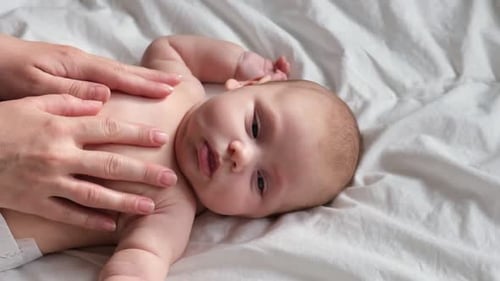 Gentle Infant Massage On Bed