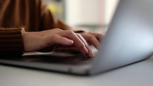 Hands Typing on Laptop Keyboard Close-up