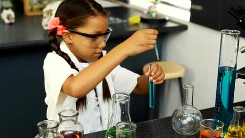 Young Girl Experimenting With Liquids in the Laboratory