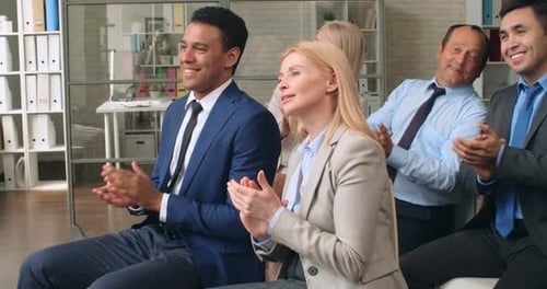 Businesspeople Applaud at Corporate Event Indoors