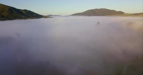 Breathtaking Aerial View of Misty Valley at Sunrise