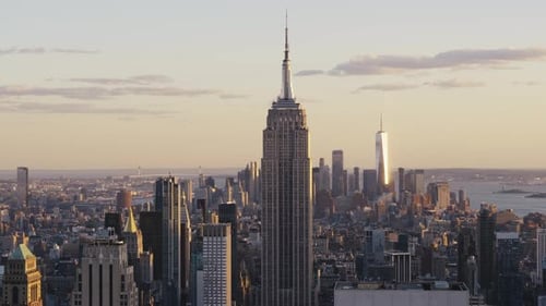 The Empire State Building at sunset with a view over Manhattan. The One World Trade Center and the S
