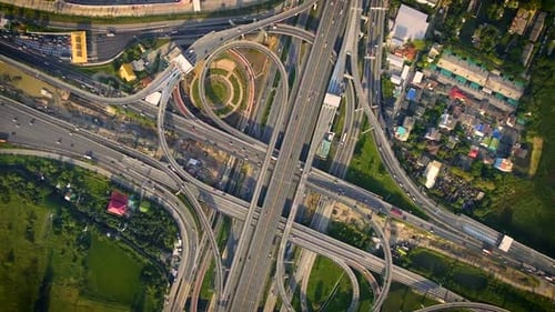 Aerial View of Highway Road Interchange with Busy Urban Traffic Speeding on Road
