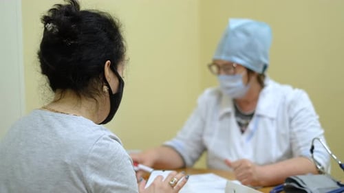 Patient Consults with Doctor in Hospital