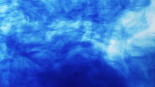 Blue Ink Flowing and Swirling in Water