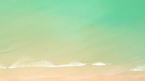 4K Aerial view top view of drone, sea waves and beautiful sand beach.