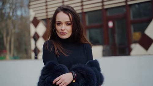 Woman Posing in Stylish Coat in an Urban Park