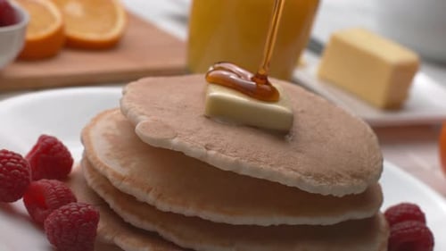 Syrup Poured on Stack of Pancakes Close Up