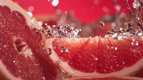 Slow Motion Shot of Grapefruit Juice Splashing Through Grapefruit Slices