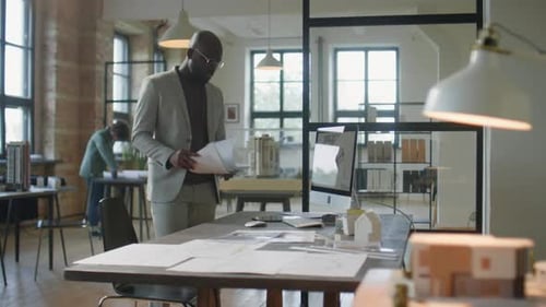African American Architect Working in Office