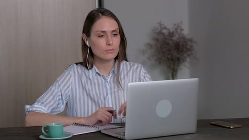 Woman Working on Laptop at Home