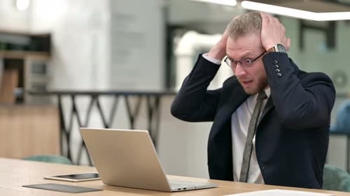 Loss, Businessman Reacting To Failure on Laptop in Office
