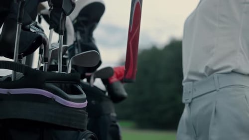 Woman Hands Hold Clubs Golf Equipment on Field