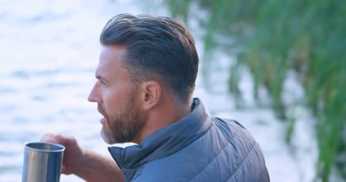 Male Hiker Having Coffee Near a Lake 4k