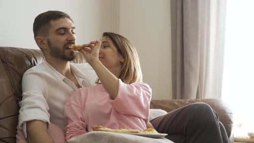 Loving Couple Shares Pizza at Home