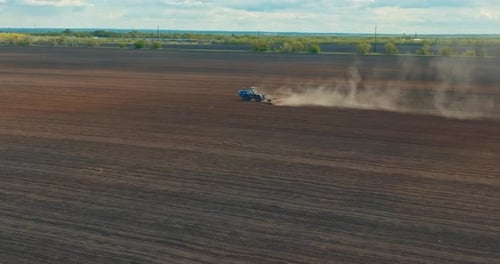 Tillage in Seeding Season in Agricultural Field Tractor is Plowing Land View From Drone Prores