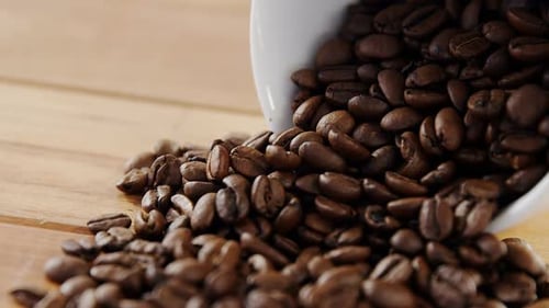Coffee Beans Spilling from a Cup Close Up