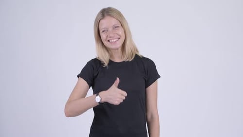 Young Woman Giving Thumbs Up in Studio