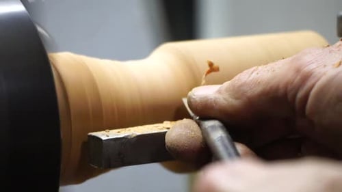 Wood Turner Shaping Cylinder on Lathe Close Up