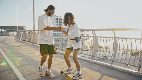 Young Woman Learning to Skateboard with Friend