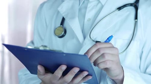 Doctor Writing Prescription In Hospital