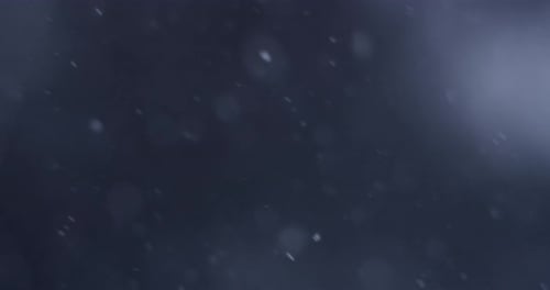 Animated Specks Falling on a Soft Blue Background