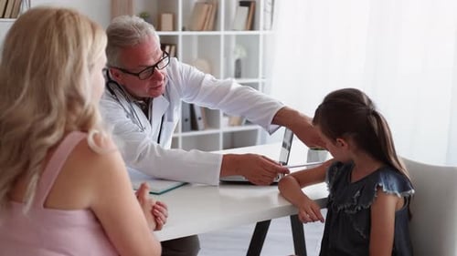 Doctor Discussing Test Results with Patient Family