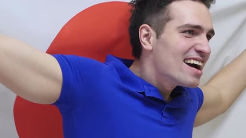 Excited Man Shouting Holding Flag Behind Back