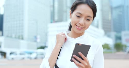 Woman use of smart phone in city