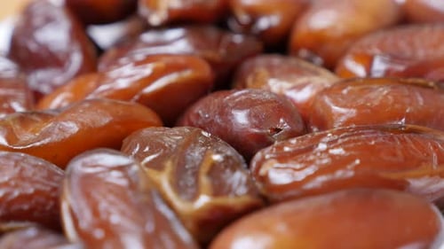 Phoenix dactylifera exotic Arabic fruit 4K 2160p 30fps UltraHD tilting footage - Close-up palm dates