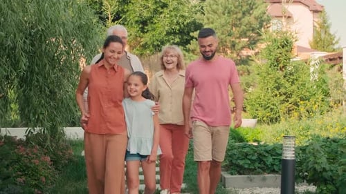 Happy Multigenerational Family Walking in Garden Together