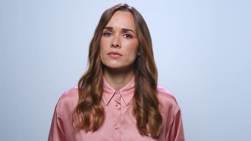 Woman Expressing Worry in Studio Setting