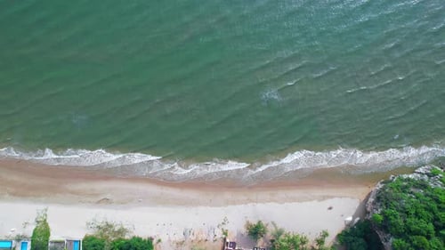 4K Aerial view top view of drone, sea waves and beautiful sand beach.