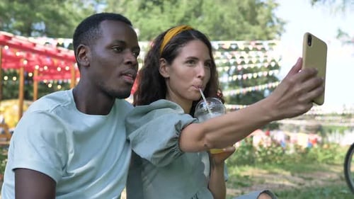 Couple Taking Selfie in Park on Sunny Day