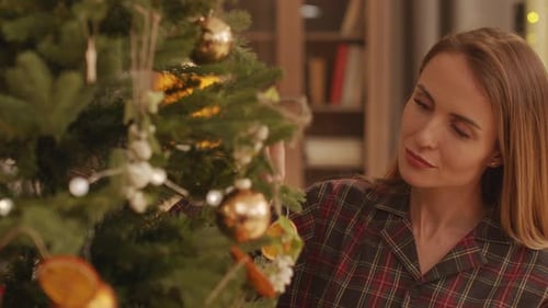 Woman Decorating Christmas Tree