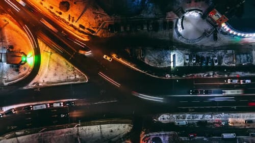 Aerial Top Down View Night Timelapse of Small Crossroad with Circular Cars in Small European City