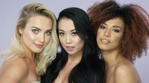 Three Smiling Young Adults with Different Hairstyles