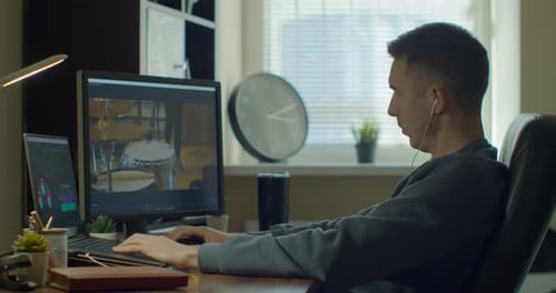 Young Adult Video Editing at Desk