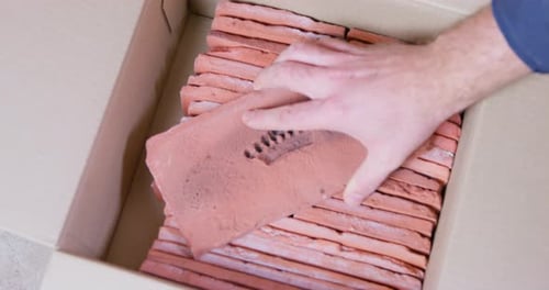 Craftsman Puts Brick Cast with Pattern on Rows of Blocks