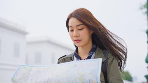 Woman Traveler Reading City Map Outdoors