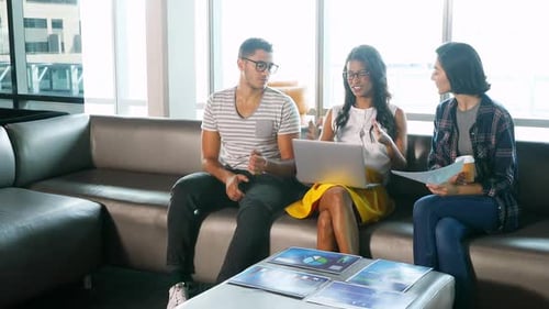 Three Adults Discussing Business on Couch