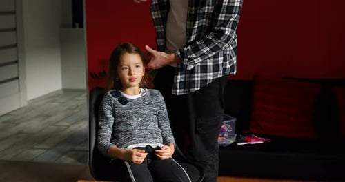 Adult Combing Child's Hair at Home